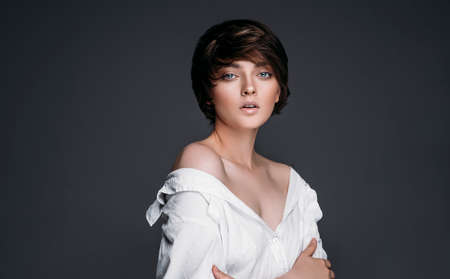 Portrait of a young brunette woman with short hairの写真素材
