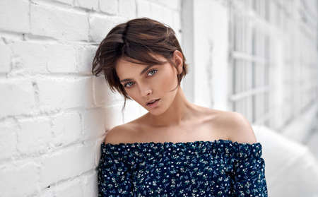 Beauty portrait of female face with natural clean skin and short hair on white wallの写真素材