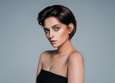 Fashion portrait of a young brunette girl with stylish short hairの写真素材