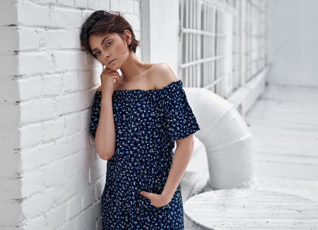 Beauiful woman with natural clean skin and short hair wear summer dress on white wallの写真素材