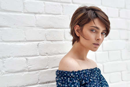 Beauty portrait of female face with natural clean skin and short hair on white wallの写真素材