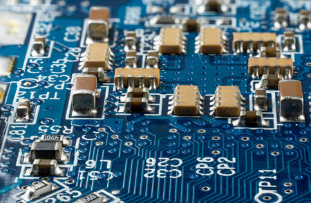 Computer blue motherboard with brown microcircuits and different electronic components, side view,...
