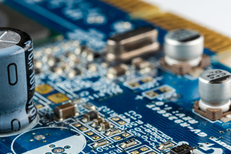 Computer blue motherboard with microchips, capacitors and various electronic components, side view, macro photoの写真素材