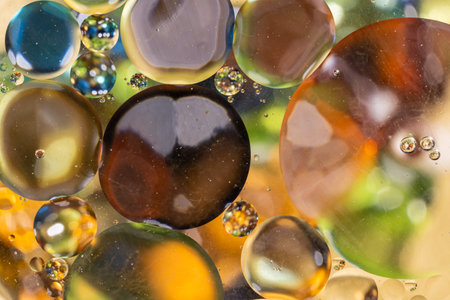 Pure oil drops in warm colors on the water