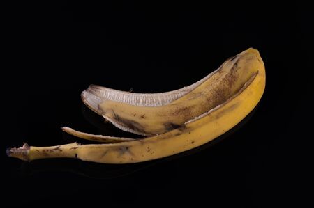 Peel from a banana on a black glass backgroundの写真素材