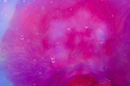 Macro world in water, explosion of a red dropの写真素材