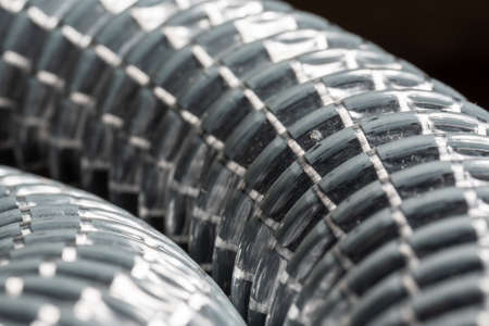 Abstract, gray flexible corrugated pipe in the form of a spring, close-upの写真素材