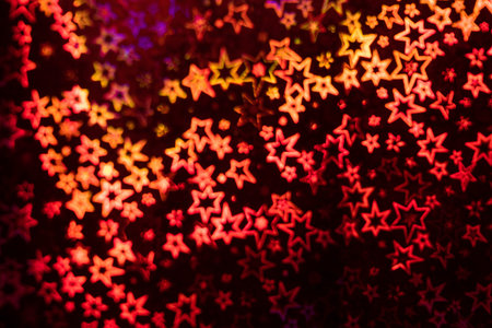 Red stars shimmer in different shades, starry bokeh, background. Abstraction.の写真素材