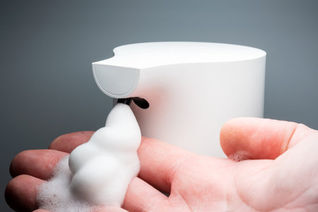 Foam from the automatic soap dispenser, wash your hands