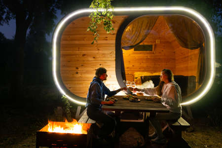 Man and zhenshchina, festive dinner by the fire in the evening.の写真素材