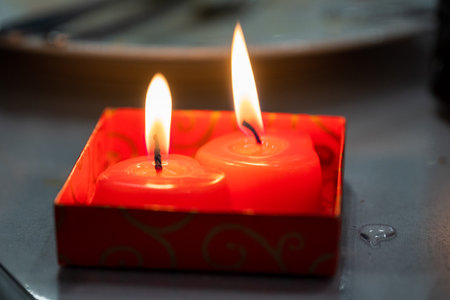Two red wedding candles in the shape of a heart.の写真素材