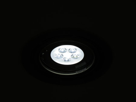 A small LED lamp in a cafe on a black background.