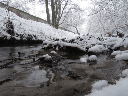 Little river and snow winter landscape.の写真素材
