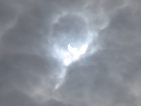 Solar eclipse on a background of clouds.