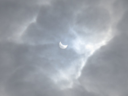 Solar eclipse on a background of clouds.