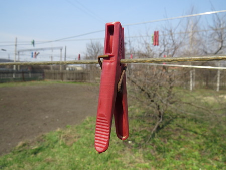 Clothespins on a clothesline in front of blue sky.の写真素材