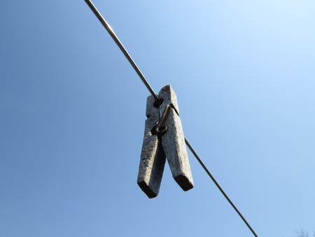 Clothespins on a clothesline in front of blue sky.の写真素材