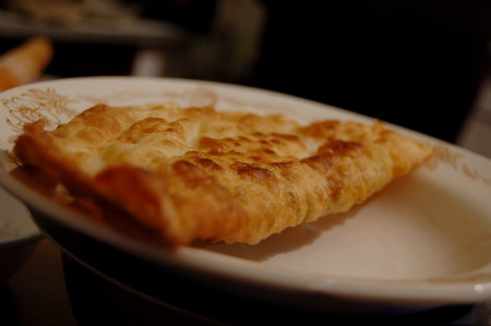 Fried cheburek meat pasty on plate.の写真素材