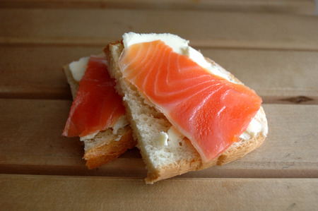 Two sandwiches with red fish and butter.の写真素材