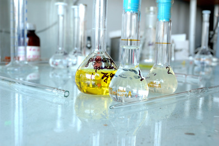 Glassware is on the table, filled with chemical solutions.の写真素材