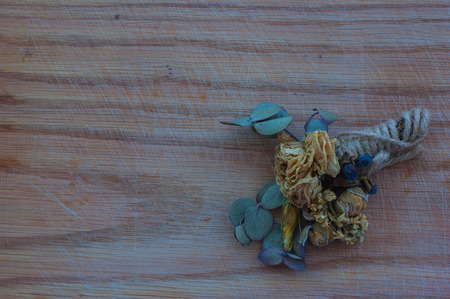 a bouquet of dried flowers on a wooden backgroundの写真素材