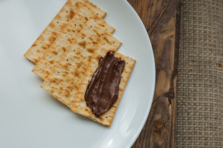 several cookies cracker on a white plate on a wooden backgroundの写真素材