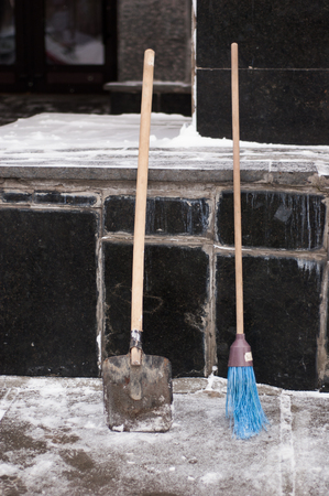 Broom and shovel for snow cleaning in winter.の写真素材