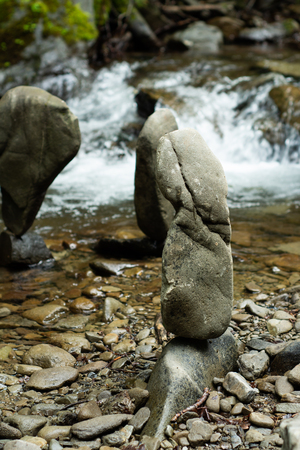 A lot of stones lying one on another on the bank of a mountain river.の写真素材