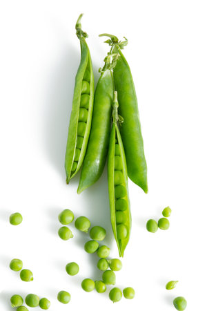 Fresh green vegetable pea pods and beans isolated on white backgroundの写真素材