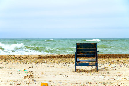 ocean view - A garden chair invites you to sit at the beachの写真素材