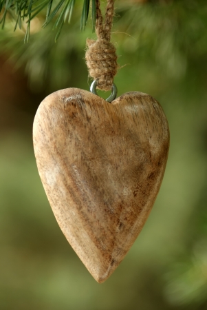 Wooden Heart - A carved wooden heart on a wooden beam の写真素材
