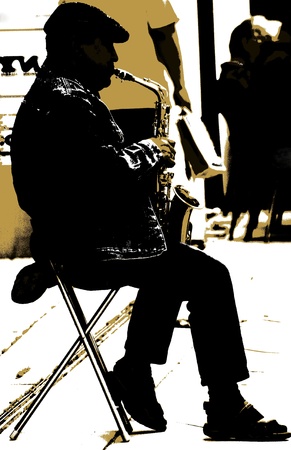 The saxophonist - A man is playing a saxophon on the street の写真素材