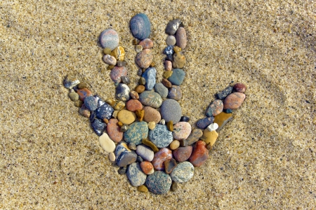 Stone hand - A hand made with little Stones on the beach  の写真素材