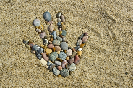 Stone hand - A hand made with little Stones on the beach  の写真素材
