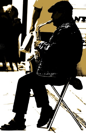 The saxophonist - A man is playing a saxophon on the street の写真素材