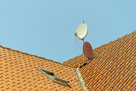 Satellite Dish - Two satellite dish on the roof of a house の写真素材