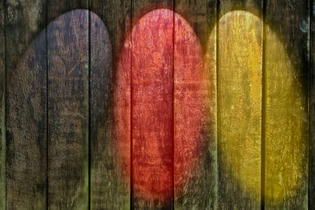 Wooden wall background with black, red and golden spot lightsの写真素材