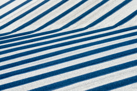 Close-up of corrugated metal sheet with blue stripes.の写真素材