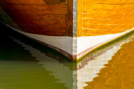 Detail of a wooden ship on the water of the river.の写真素材