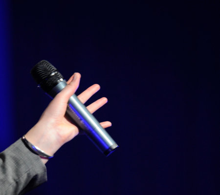 Hand holding microphoneの写真素材