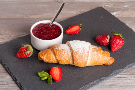 fresh croissant with jam for breakfast, horizontal, close upの写真素材