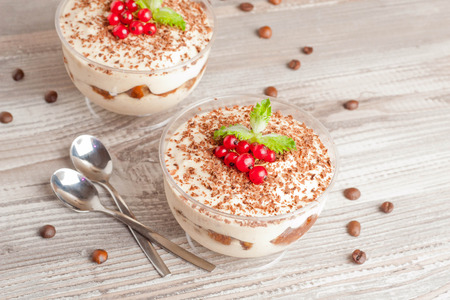 Tiramisu with red currant and chocolate in a glass, close upの写真素材