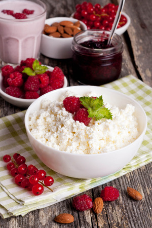 breakfast with fresh homemade cottage cheese with raspberry, vertical, close upの写真素材