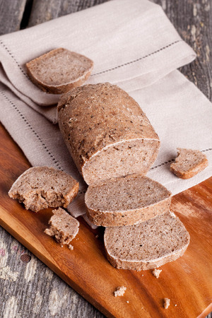 A slice of bread with butter on a chopping board. close up, verticalの写真素材