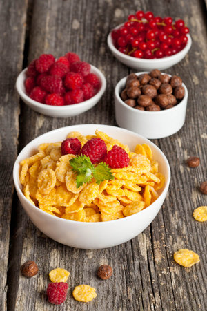 Cornflakes and different Berries, vertical, close up