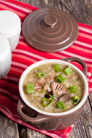 Mushroom cream soup in a bowl close-up verticalの写真素材