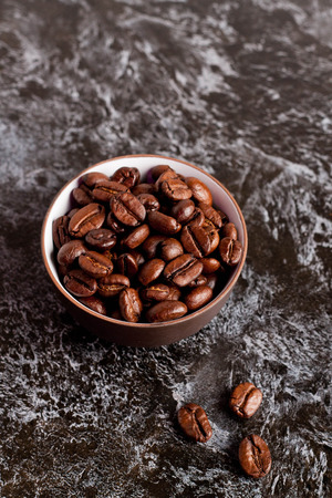 coffee beans in a bowl, close-up, verticalの写真素材