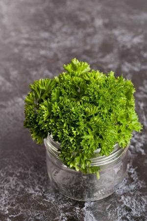 fresh parsley in a jar, greens, vertical, close upの写真素材