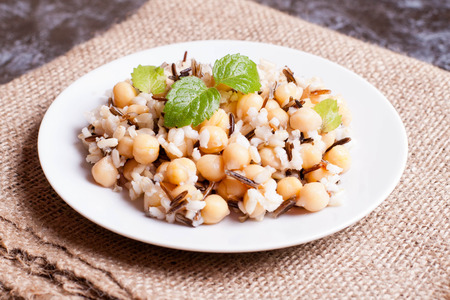 Warm salad with brown rice, chickpeas, wild rice and mint. close up, horizontalの写真素材