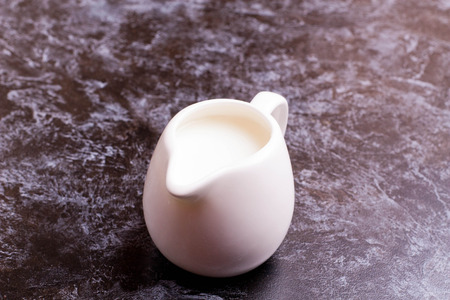 White jug with milk, close up, horizontalの写真素材